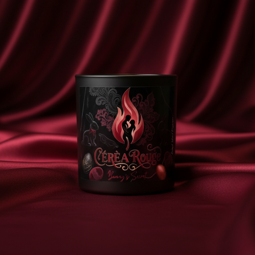 Black mug with a red and pink design on a red fabric background