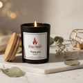 Black candle with a label on a white background