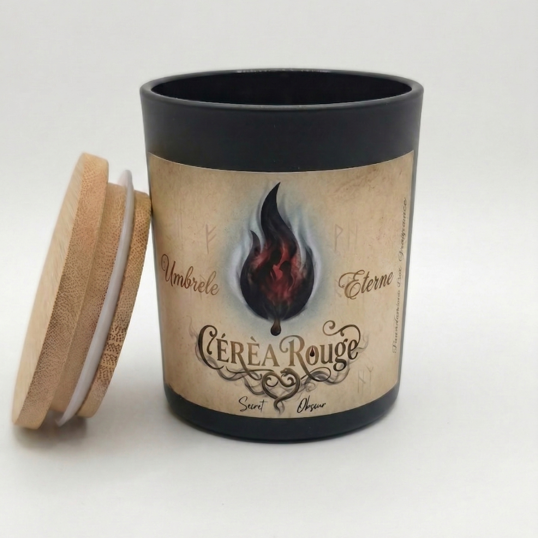 Candle with a decorative label featuring a flame design on a white background