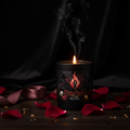 Candle in a black container with decorative design and text on a white background